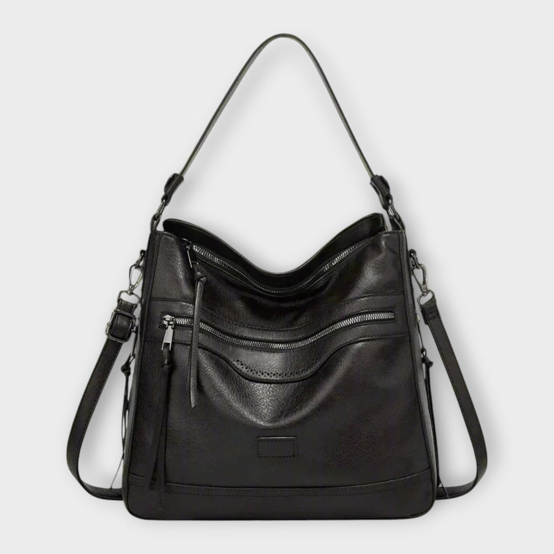 Borsa a tracolla Amélie nera in primo piano, con dettagli classici e chiusura visibile.