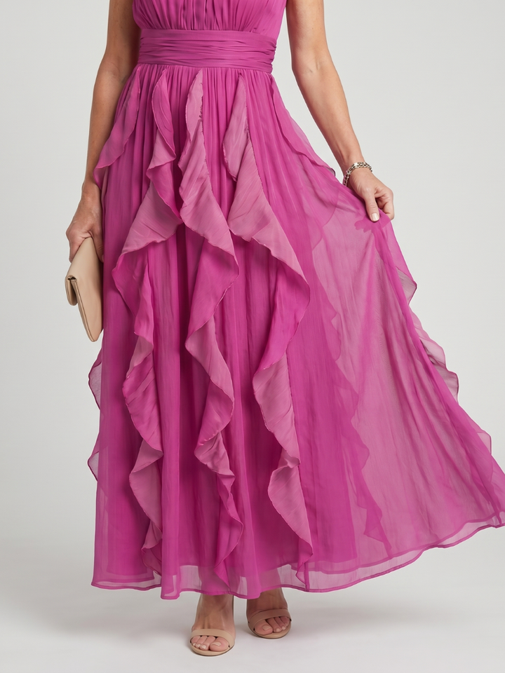 Anthea, abito lungo rosa con gonna a balze a strati, vista laterale che mostra il movimento fluido del tessuto.