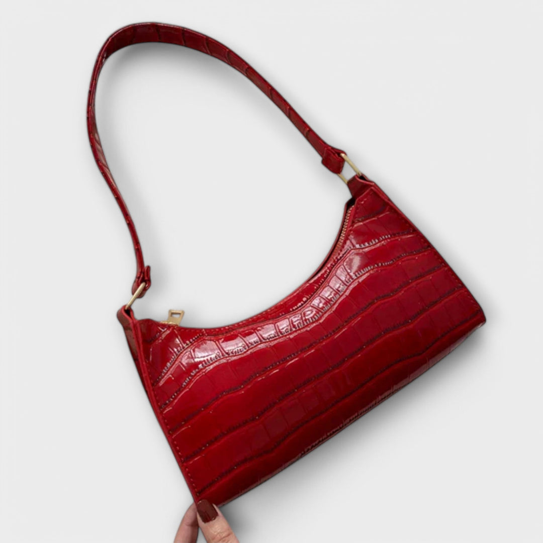 Dettaglio dei manici della borsa Bianca rosa, che sembrano comodi e resistenti per l'uso prolungato.