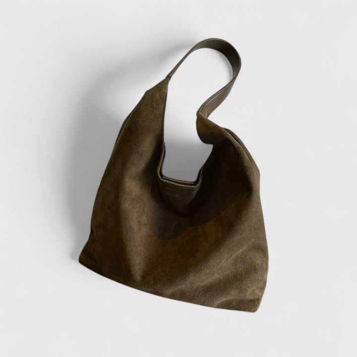 Primo piano della texture del materiale della borsa Cassia, suggerendo qualità e resistenza