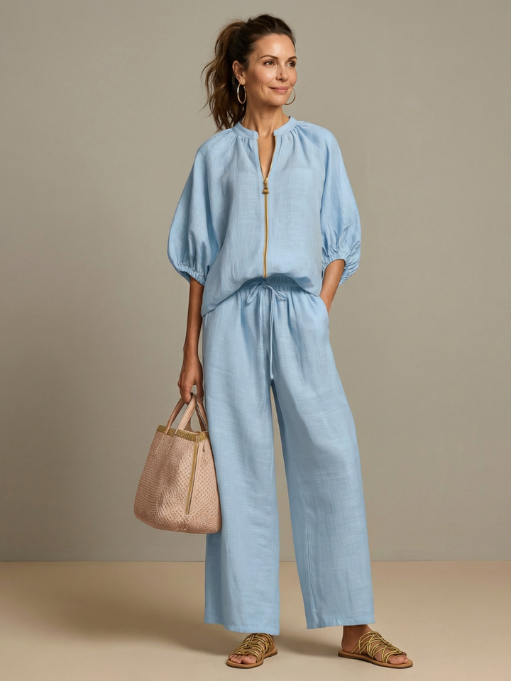 Pantaloni a gamba larga Cleo neri, vista frontale su modella in ambiente urbano.