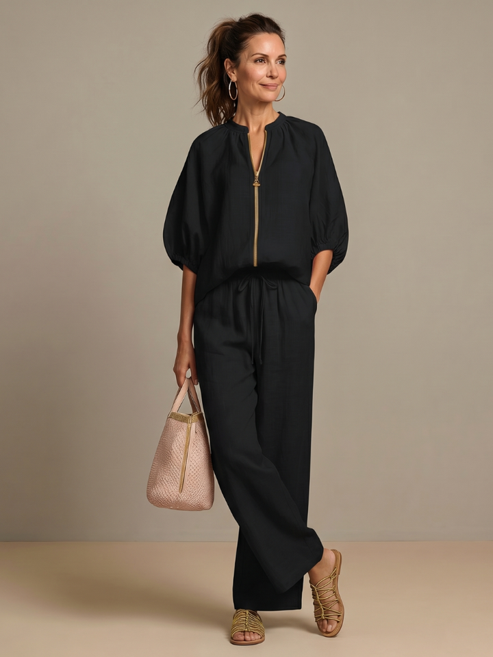 Modella che mostra i pantaloni a gamba larga Cleo neri in una posa elegante.