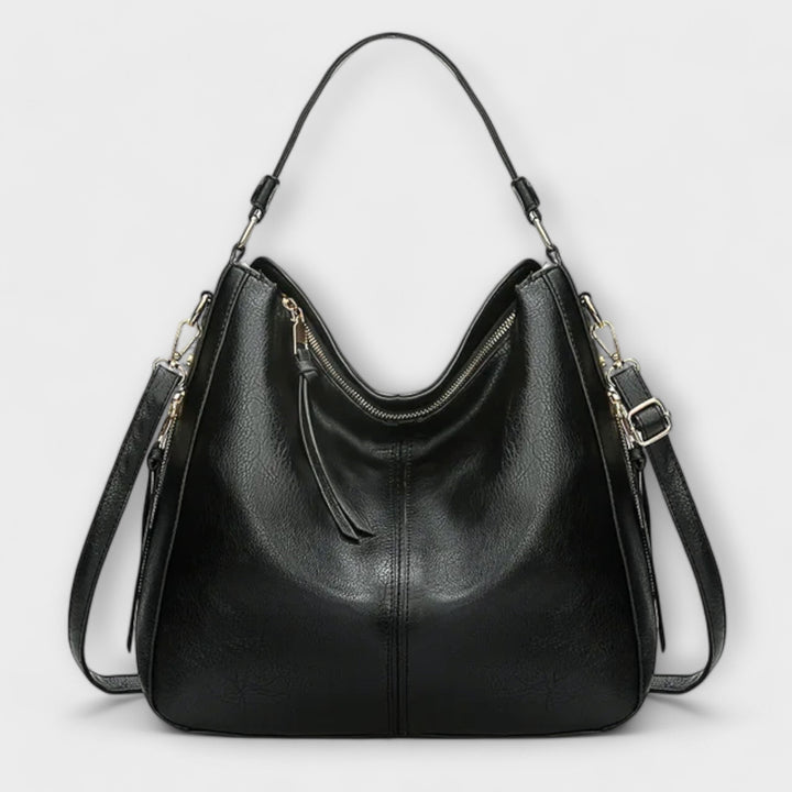 Borsa elegante Elina in una tonalità di blu, catturata con una luce naturale che ne esalta la brillantezza del colore.