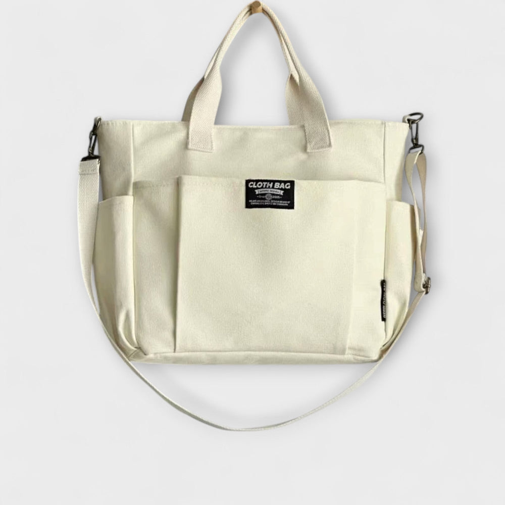 Dettaglio della borsa tote Ginevra bianca, con cerniera chiusa e tasca interna visibile, per un'organizzazione impeccabile.
