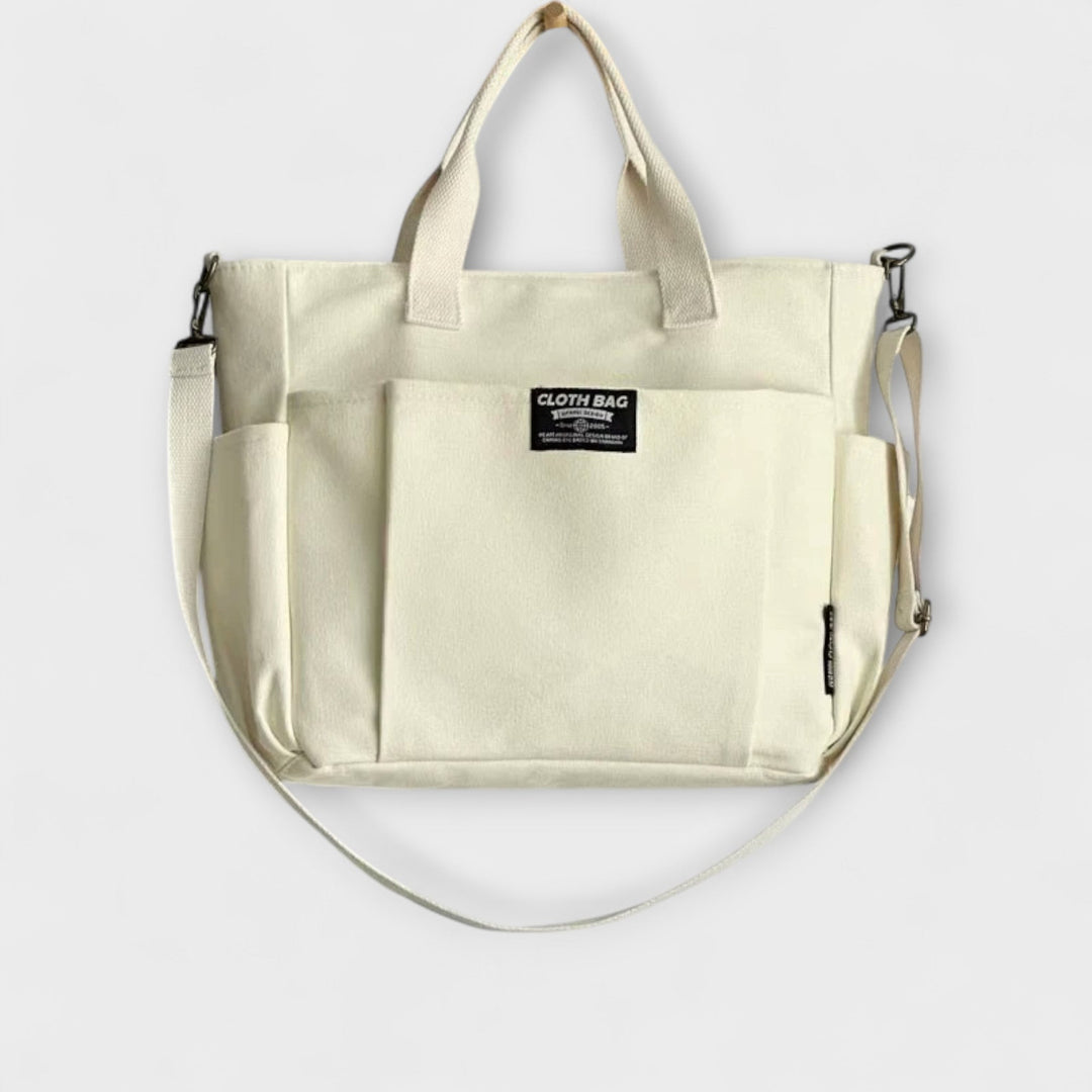 Dettaglio della borsa tote Ginevra bianca, con cerniera chiusa e tasca interna visibile, per un'organizzazione impeccabile.