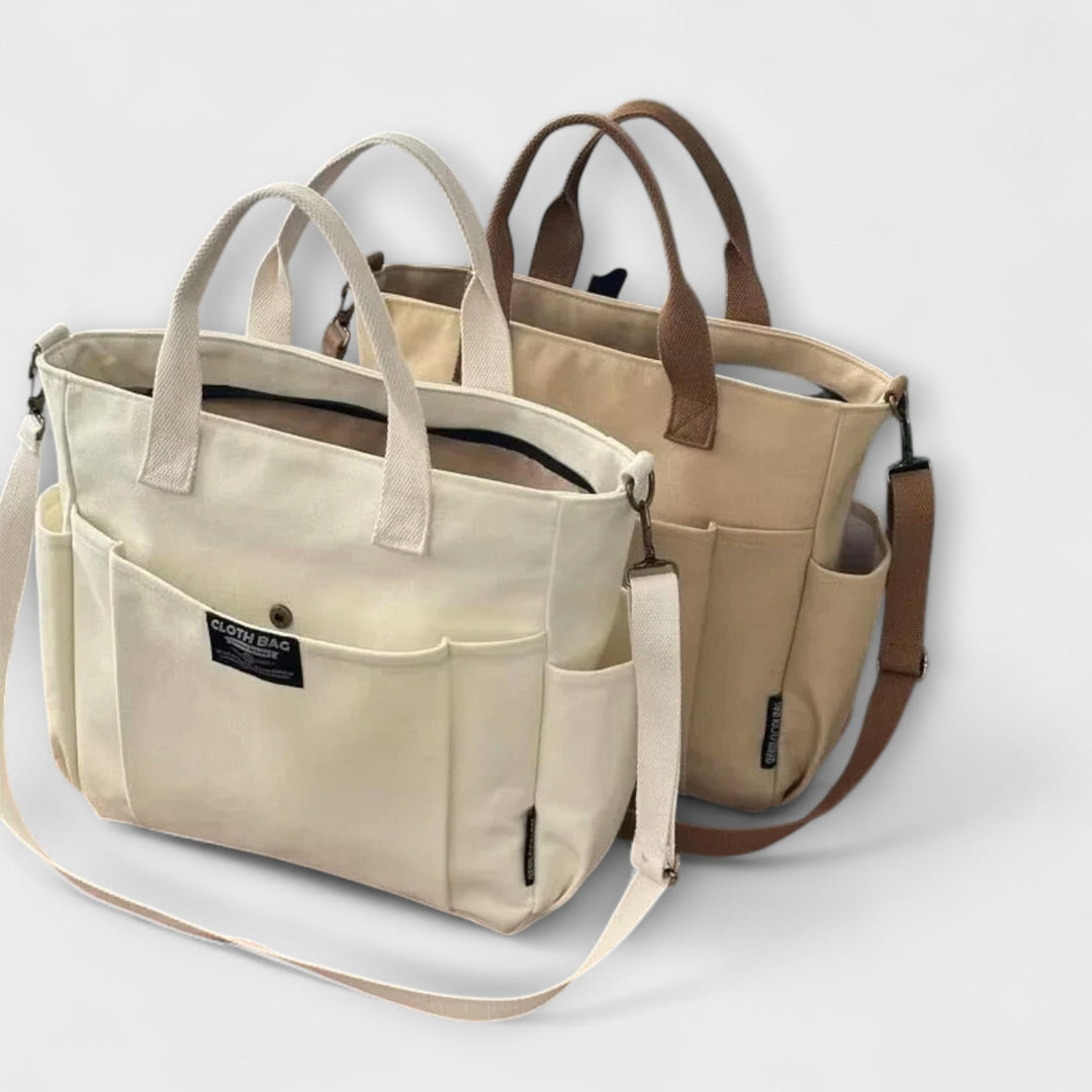 La borsa tote Ginevra bianca posizionata su una superficie, con il logo discreto e le cuciture pulite in primo piano.