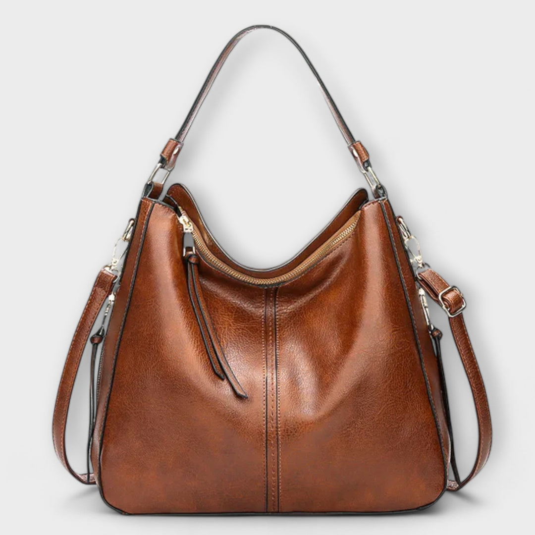 Borsa Indira nera, vista frontale, su sfondo neutro, che mostra la sua forma elegante e le dimensioni generose.