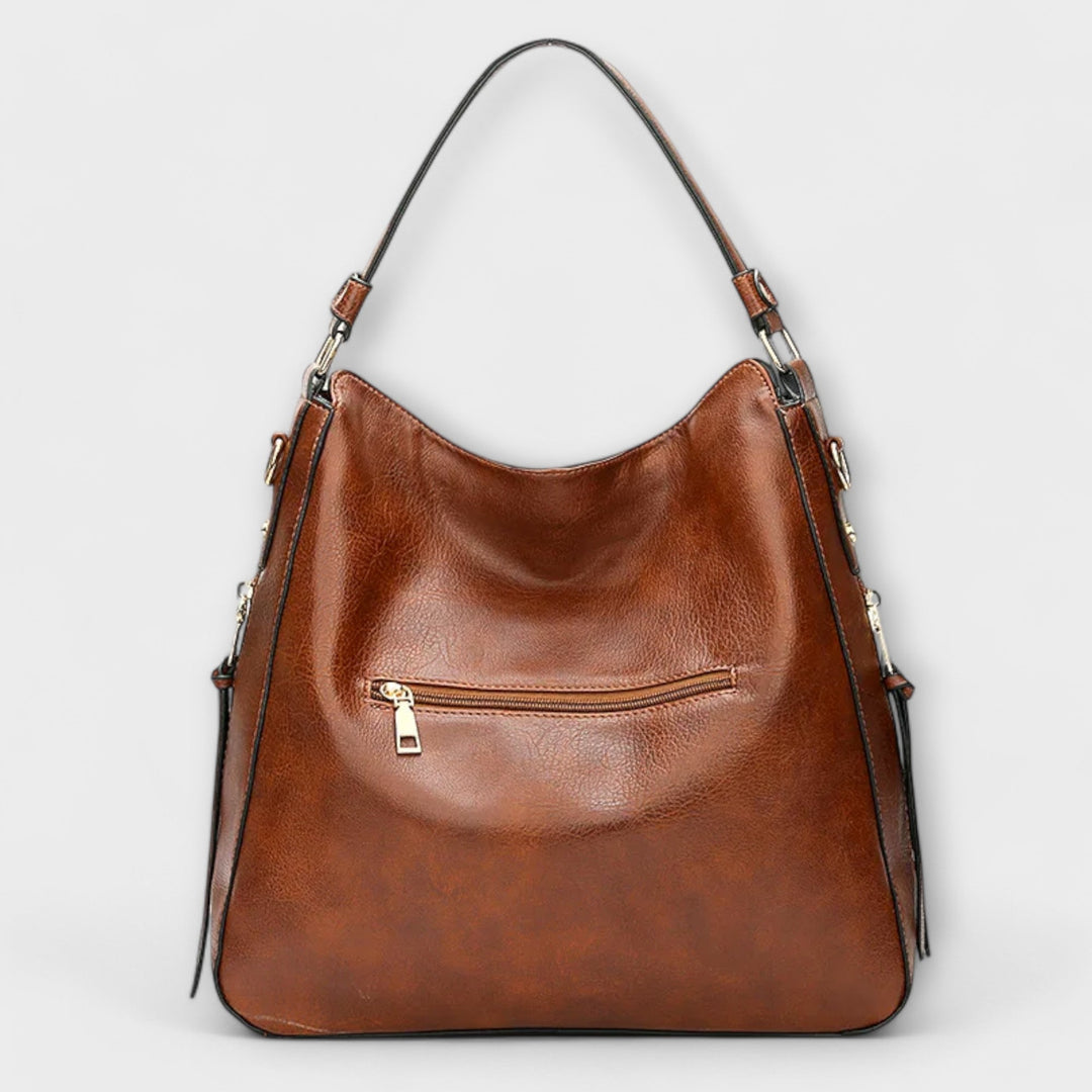 Borsa Indira blu, dettaglio della chiusura e della texture del materiale, evidenziando la qualità della finitura.