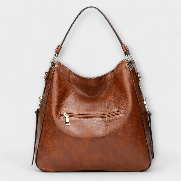 Borsa Indira blu, dettaglio della chiusura e della texture del materiale, evidenziando la qualità della finitura.