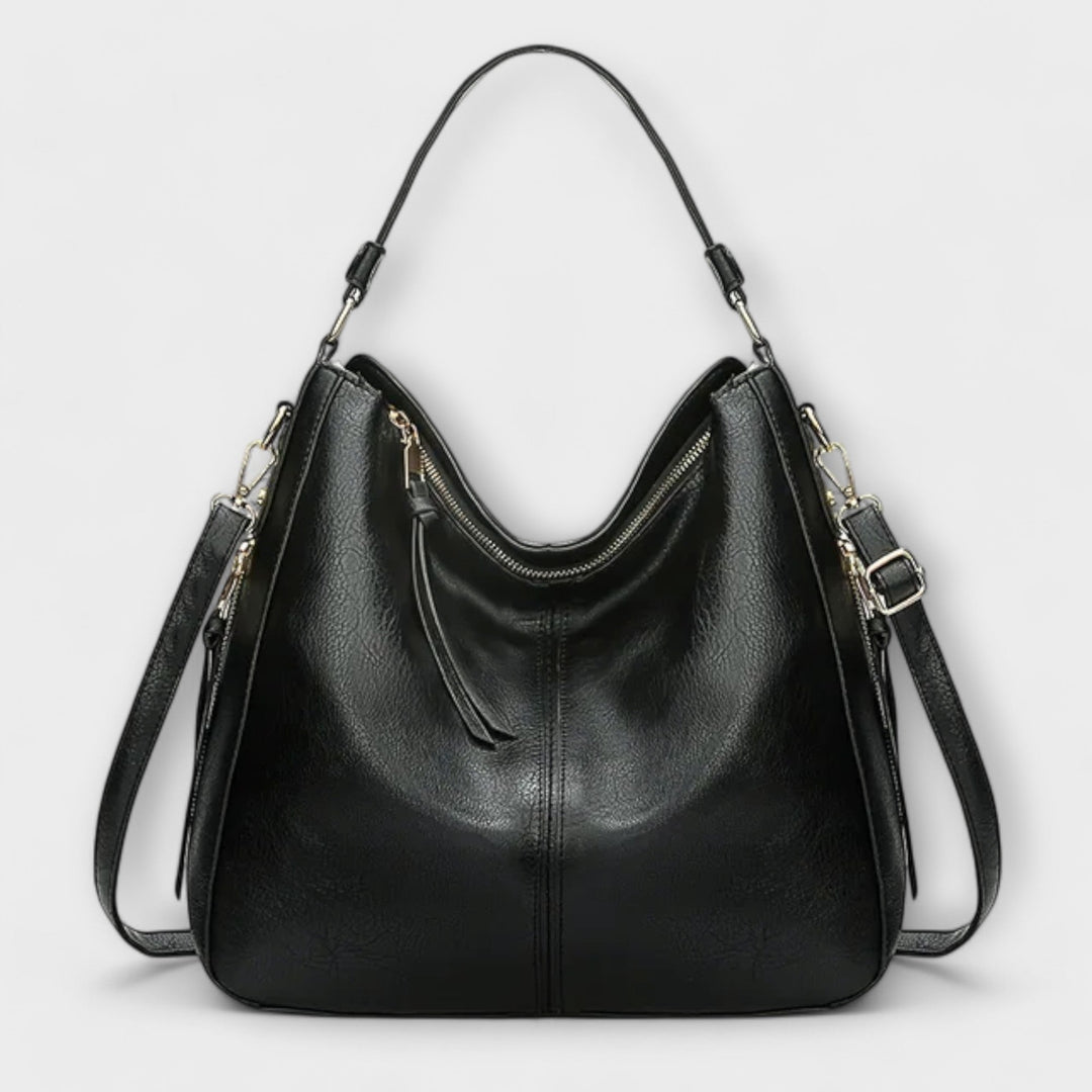 Dettaglio del manico della borsa Indira blu, con cuciture precise e un design confortevole per il trasporto.