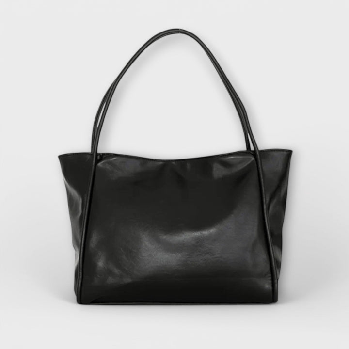 Borsa tote vintage Isabelle nera, vista frontale su sfondo neutro, con manici ben visibili.