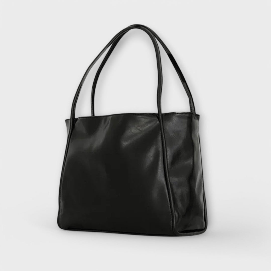 Borsa Isabelle marrone scuro, angolazione leggermente laterale che mostra la texture del materiale.