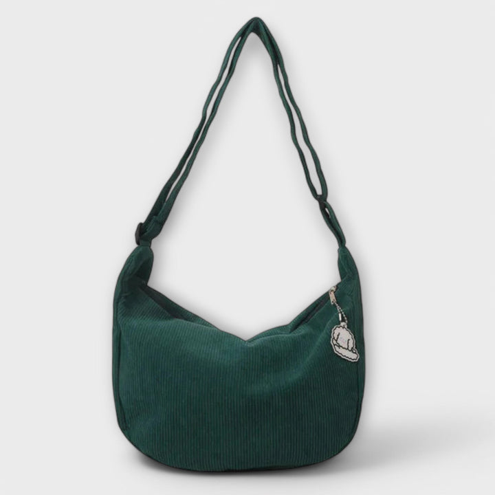Dettaglio del manico regolabile della borsa a spalla resistente beige, per un comfort personalizzato.