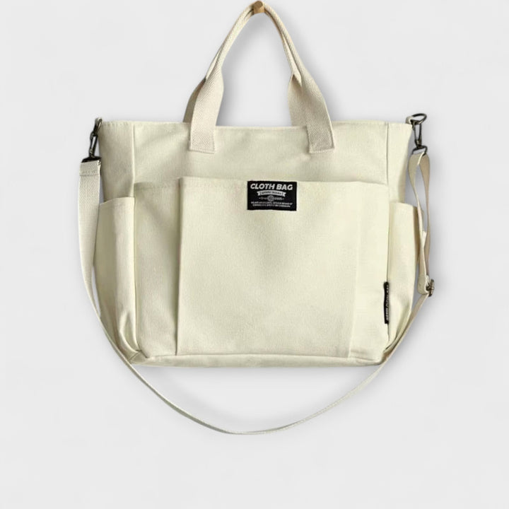 Borsa tote versatile Maia bianca, angolazione laterale, mostrando la capienza e la texture della tela.