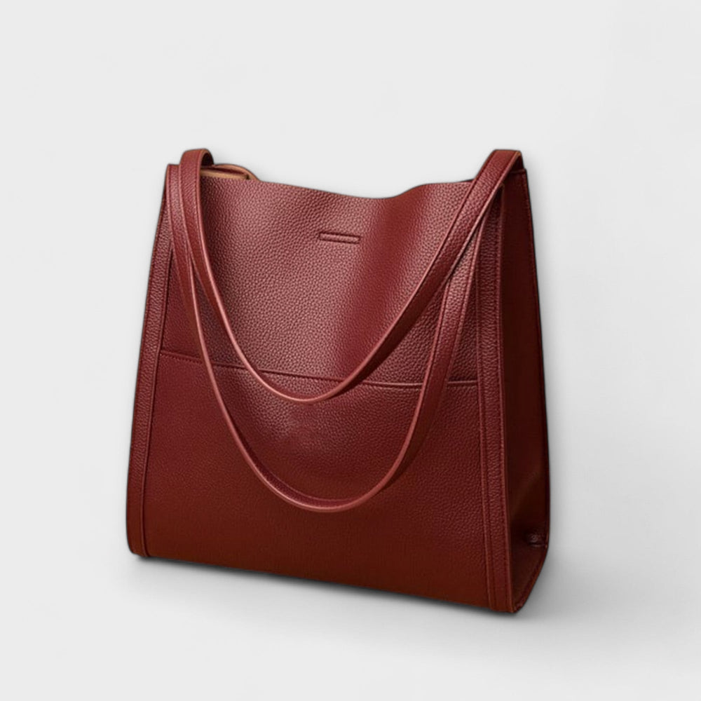 Borsa a tracolla Mirella verde, posizionata su una superficie chiara, mostra la sua forma e capienza.