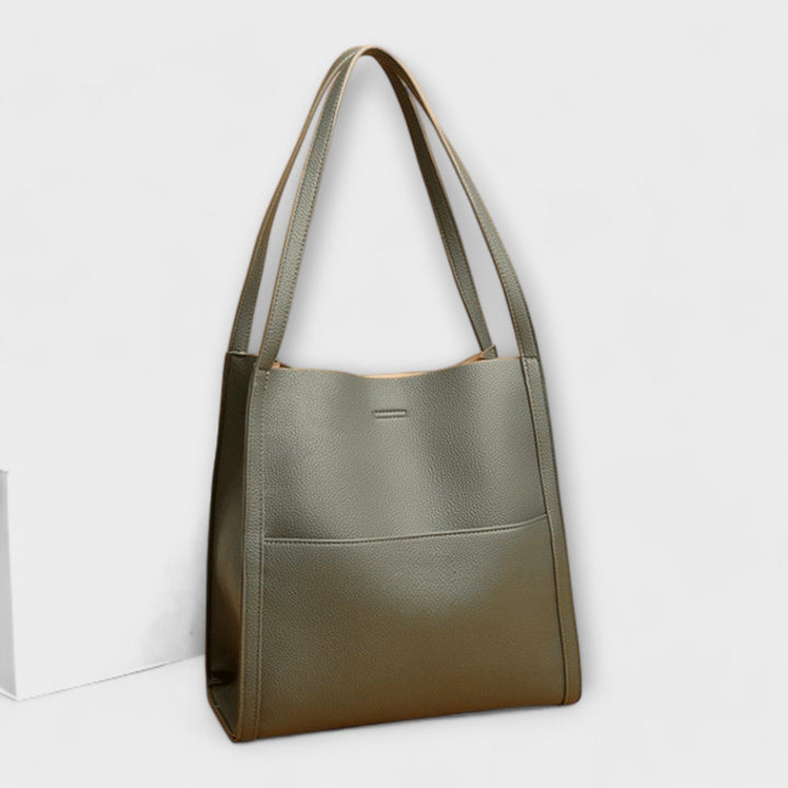 Borsa a tracolla grigia, vista laterale che evidenzia la profondità e la struttura del design elegante.