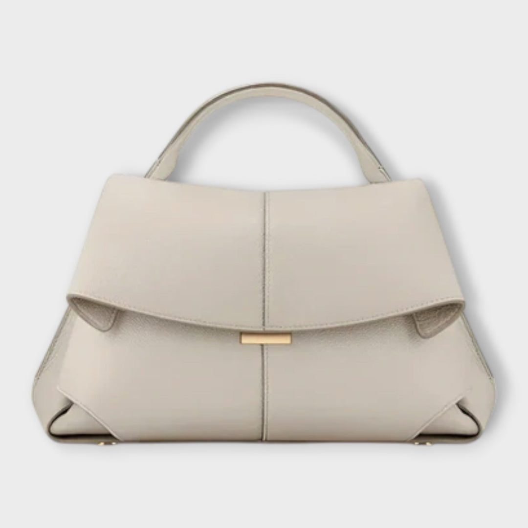 Modella che indossa la borsa a mano Ophelia marrone, in un contesto urbano elegante.
