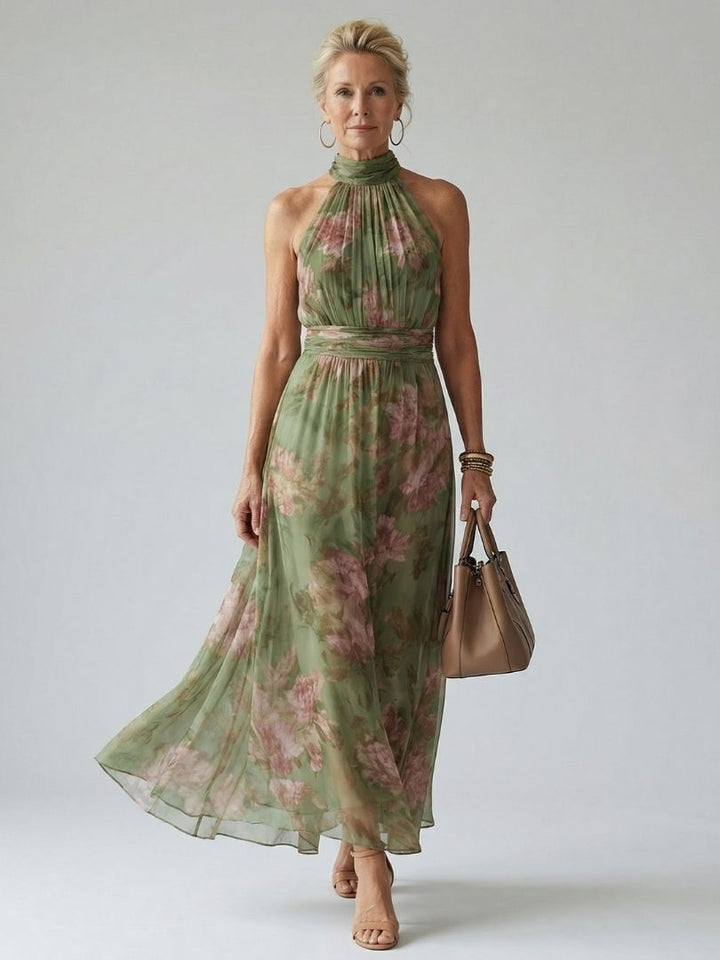 Abito midi halter verde salvia, vista frontale, con dettagli arricciati sul corpetto e motivo floreale delicato.